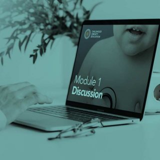 E-Learning image, displaying a laptop and it's user's arm. The laptop screen displays the Image for Core Module 1 in the training course.